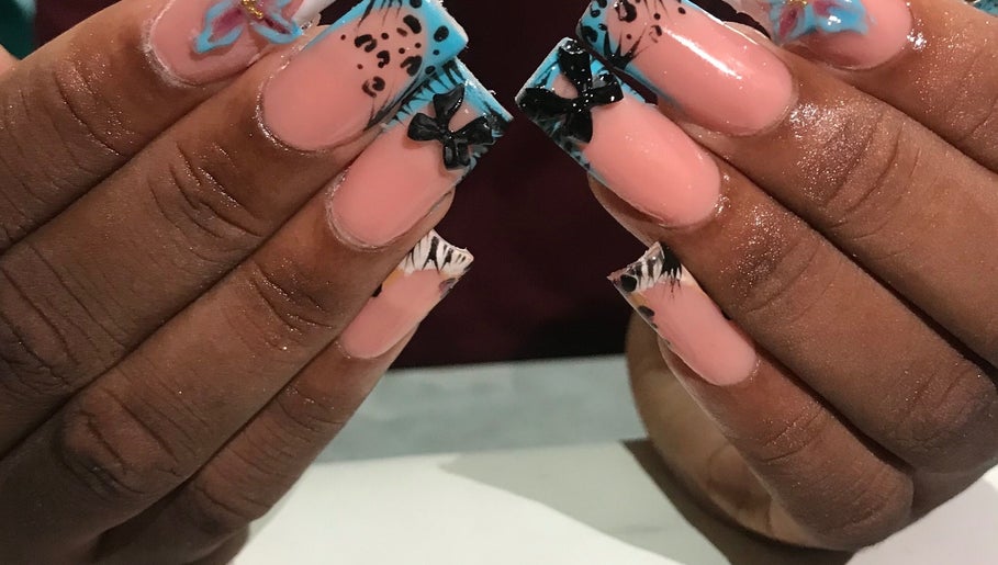 Stylish nail art with bows at Deluxee Nails By Abby in Draxhall, St. Ann Parish, JM.