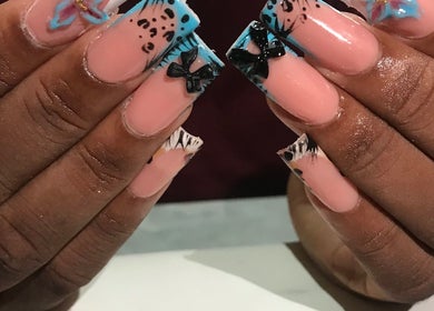 Stylish nail art with bows at Deluxee Nails By Abby in Draxhall, St. Ann Parish, JM.