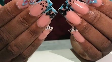Stylish nail art with bows at Deluxee Nails By Abby in Draxhall, St. Ann Parish, JM.