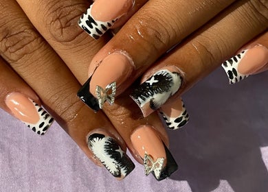 Stylish nail art with butterfly accents at Deluxee Nails By Abby, Draxhall, St. Ann Parish, JM.