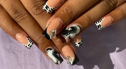 Stylish nail art with butterfly accents at Deluxee Nails By Abby, Draxhall, St. Ann Parish, JM.