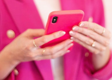 Close-up of hands holding a pink phone at Blush Nail Boutique, Pretoria, Gauteng, ZA.