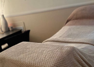 Comfortable treatment bed at MEMA Skin & Wellness Clinic in Lytham, GB, highlighting a serene ambiance.