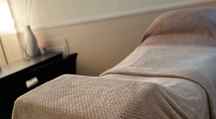 Comfortable treatment bed at MEMA Skin & Wellness Clinic in Lytham, GB, highlighting a serene ambiance.