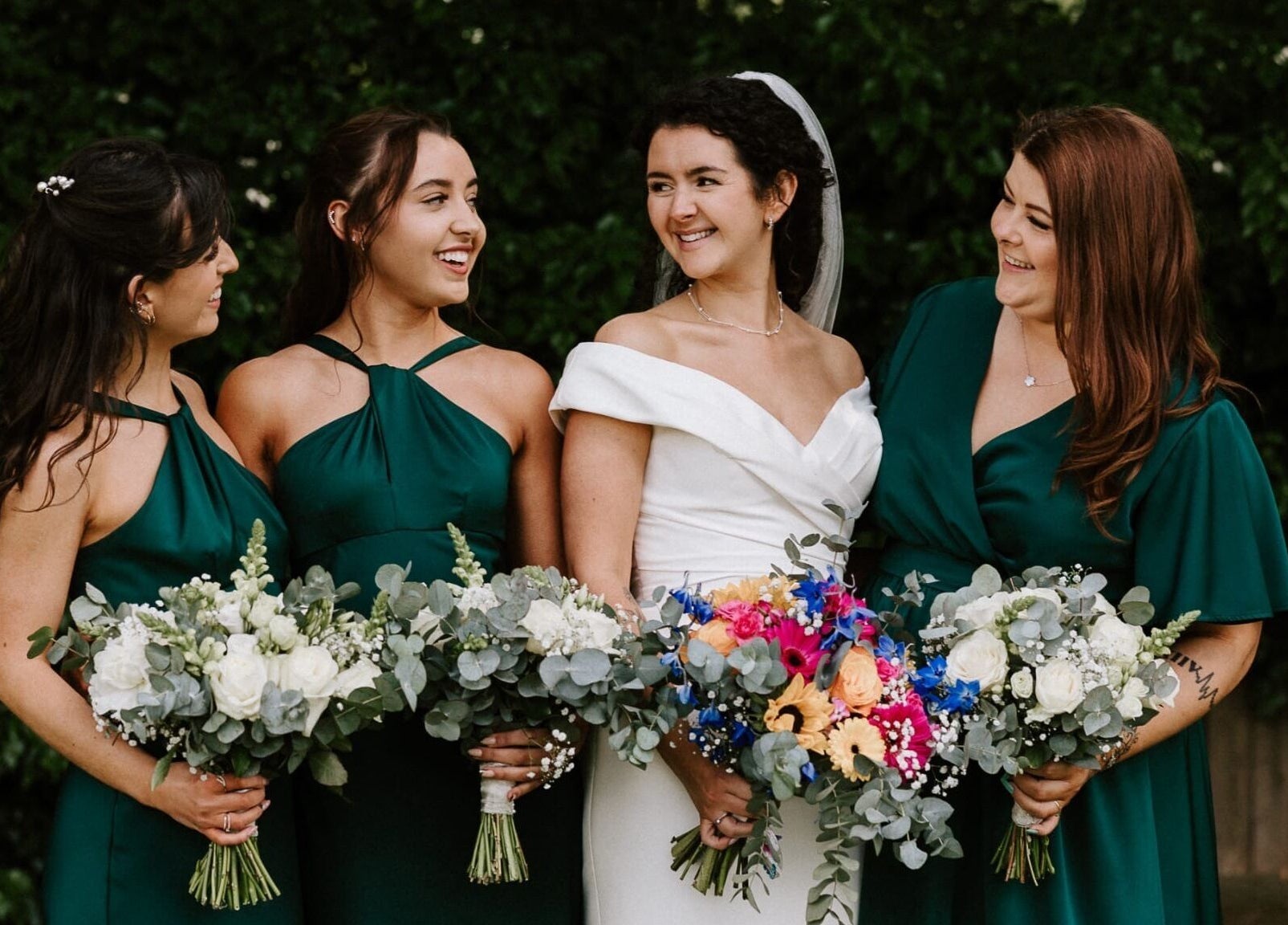 Bridesmaids with bride holding vibrant bouquets at JOAM Glow Spray Tanning, Hairdressing, Waxing, Weddings Peterborough.