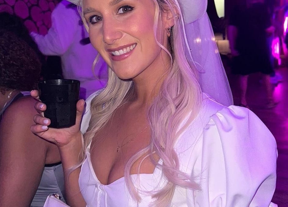Smiling woman at event with blonde hair and drink, showcasing beauty at JOAM Glow Spray Tanning, Peterborough, England, GB.