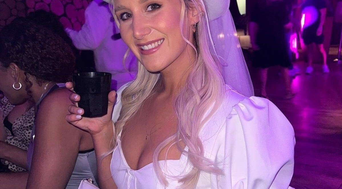 Smiling woman at event with blonde hair and drink, showcasing beauty at JOAM Glow Spray Tanning, Peterborough, England, GB.