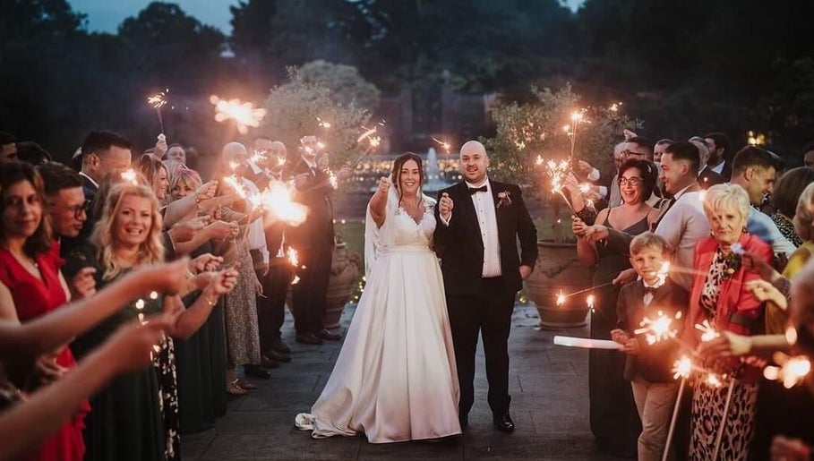 Wedding guests with sparklers at JOAM Glow London Mobile Spray Tanning Sienna X, London, England, GB.