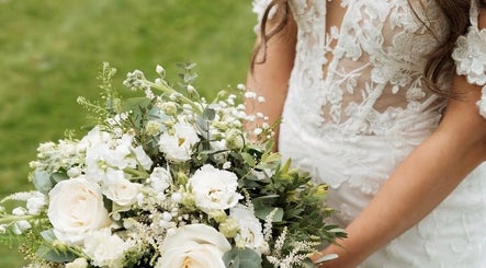 Bride holding bouquet in lace gown at JOAM Glow London Mobile Spray Tanning Sienna X, London, England, GB.