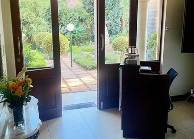 Entrance of Mirabella Aesthetics Health & Beauty Clinic, Pretoria, Gauteng, ZA, showcasing a garden view.