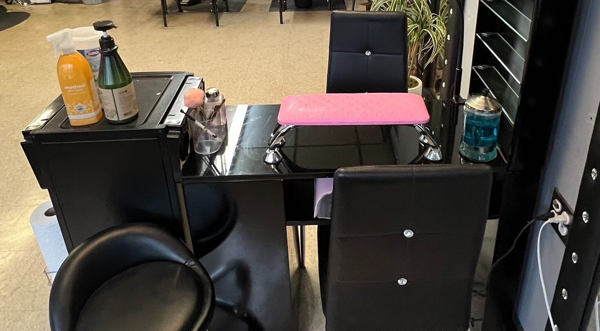 Elegant nail station at Nick Nailed It! in Trenton, New Jersey, US, featuring chic black chairs and manicure tools.