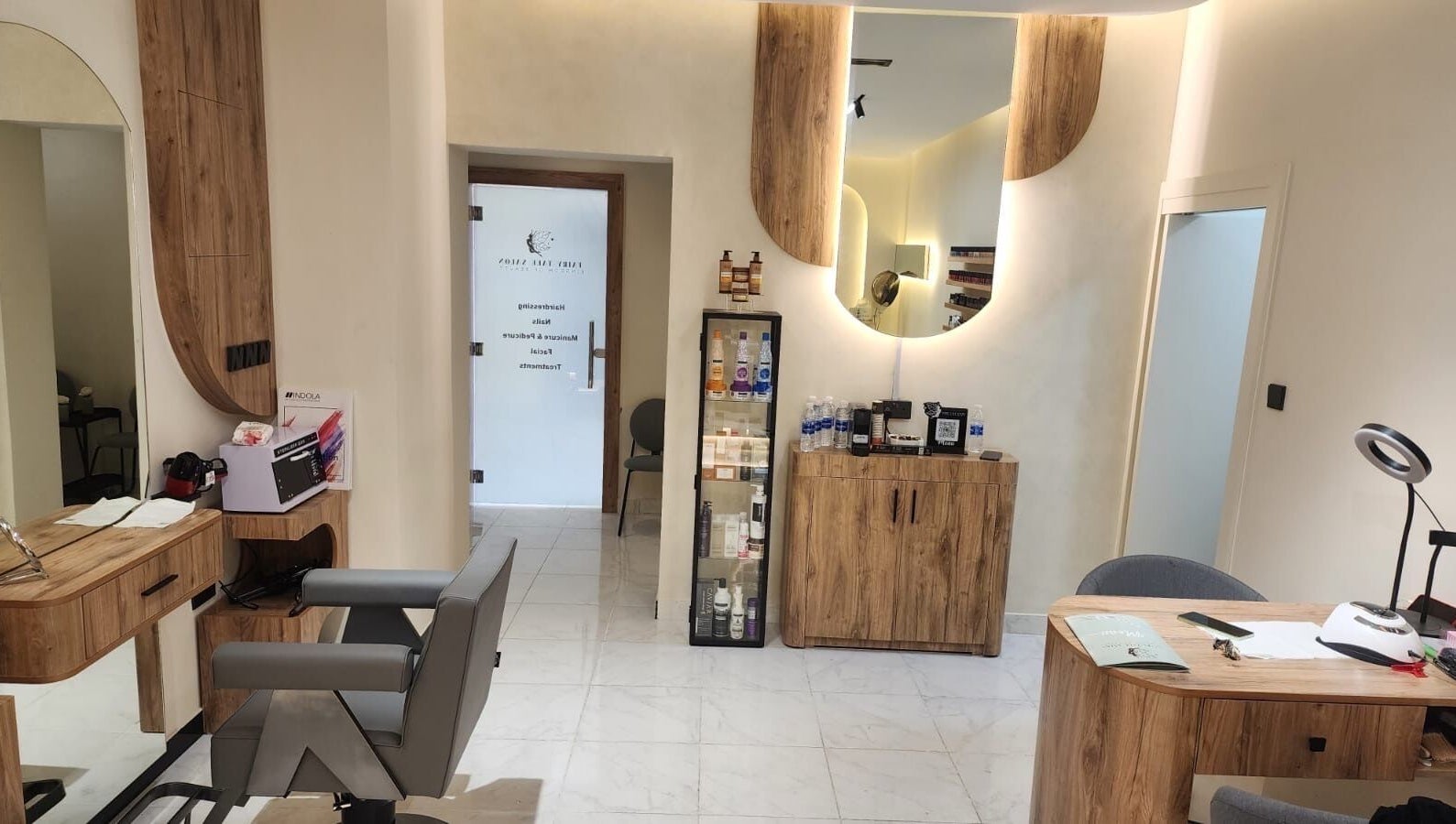 Interior view of FairyTale Salon - Muscat Grand Mall in Muscat, showcasing chic wooden decor and beauty products.