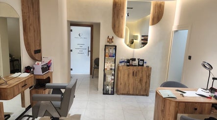 Interior view of FairyTale Salon - Muscat Grand Mall in Muscat, showcasing chic wooden decor and beauty products.
