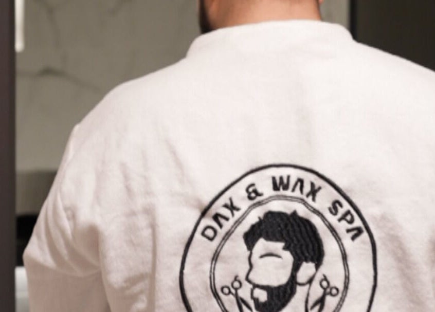 Back view of a robe featuring Dax and Wax (Barbershop & Spa) logo in Muscat, Muscat Governorate, OM.