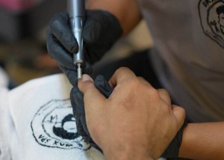 Nail technician performing manicure at Dax and Wax (Barbershop & Spa), Muscat, Muscat Governorate, OM.