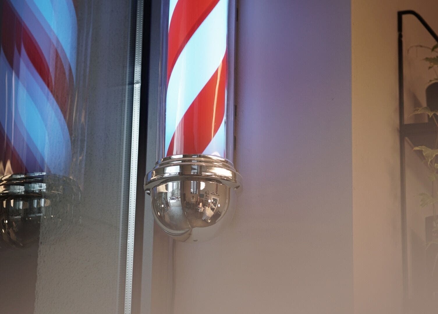 Iconic barber pole at Mave Barbershop | Rīga, LV creating a classic ambiance for grooming services.