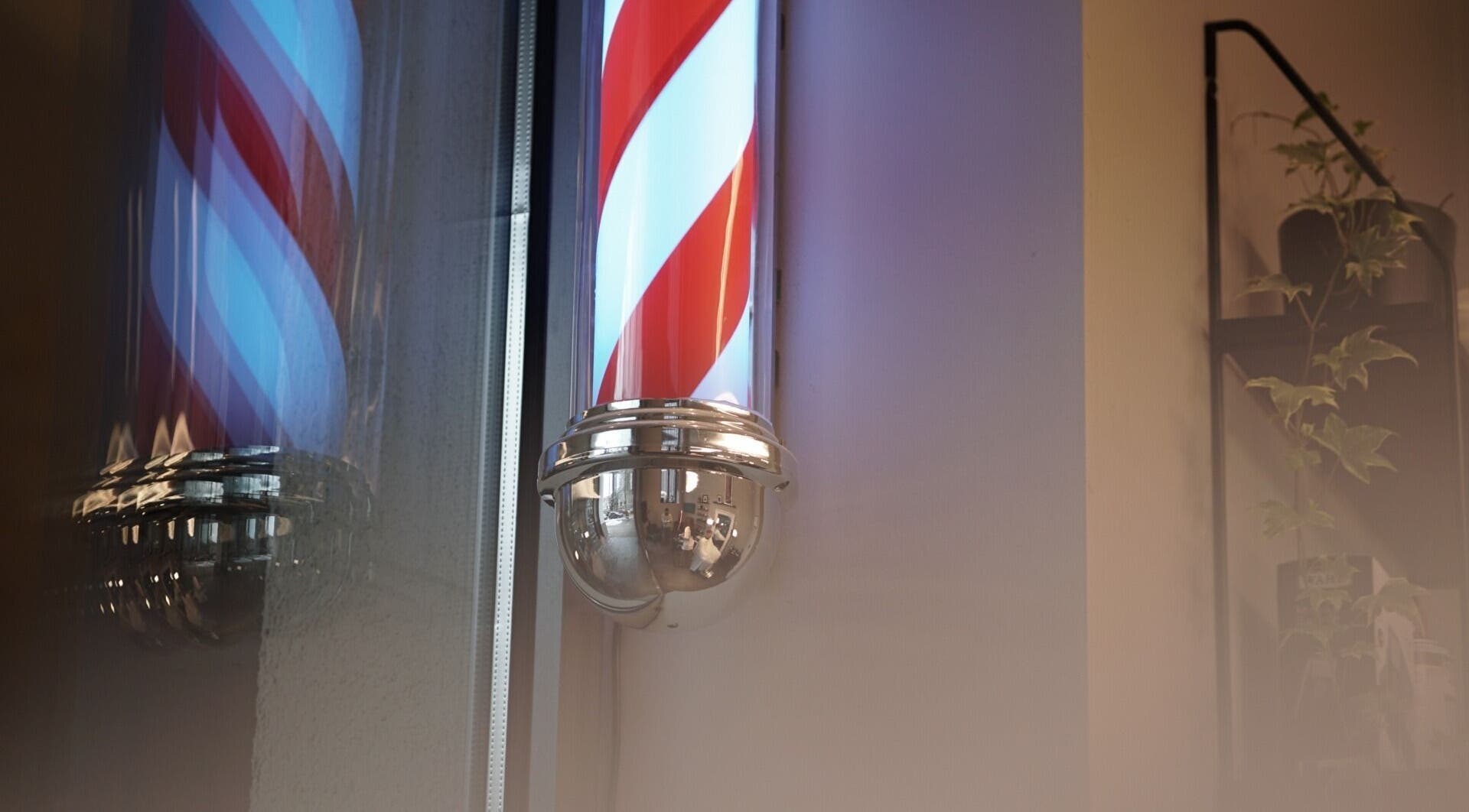 Iconic barber pole at Mave Barbershop | Rīga, LV creating a classic ambiance for grooming services.