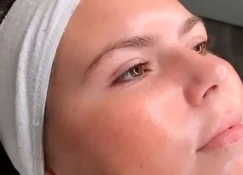 Relaxed woman with glowing skin at The Skin Specialist in Copthorne, England, GB.