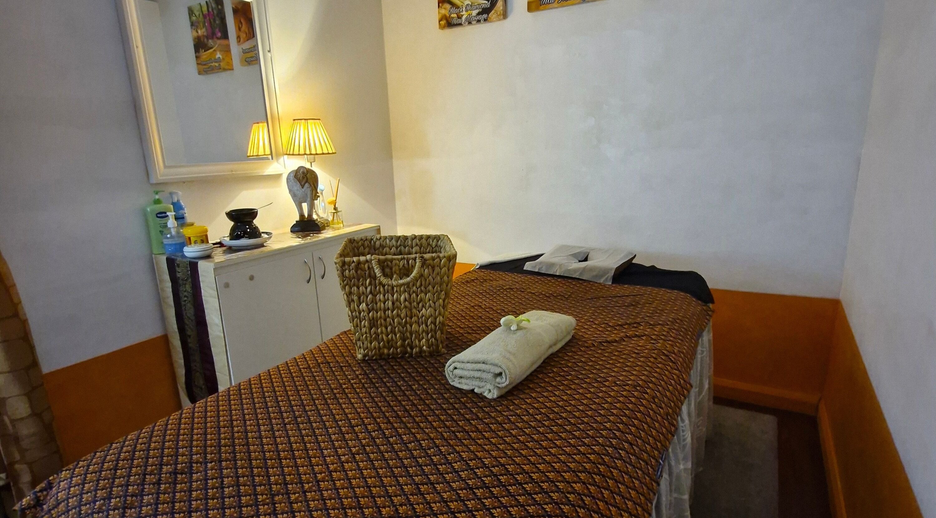 Relaxing massage room at Black Diamond Massage in Woonona, New South Wales, AU, with cozy decor and soft lighting.