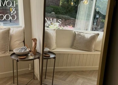 Inviting seating area at Doctor Cliona, Ripon, England, GB. Features soft cushions and a chic side table.