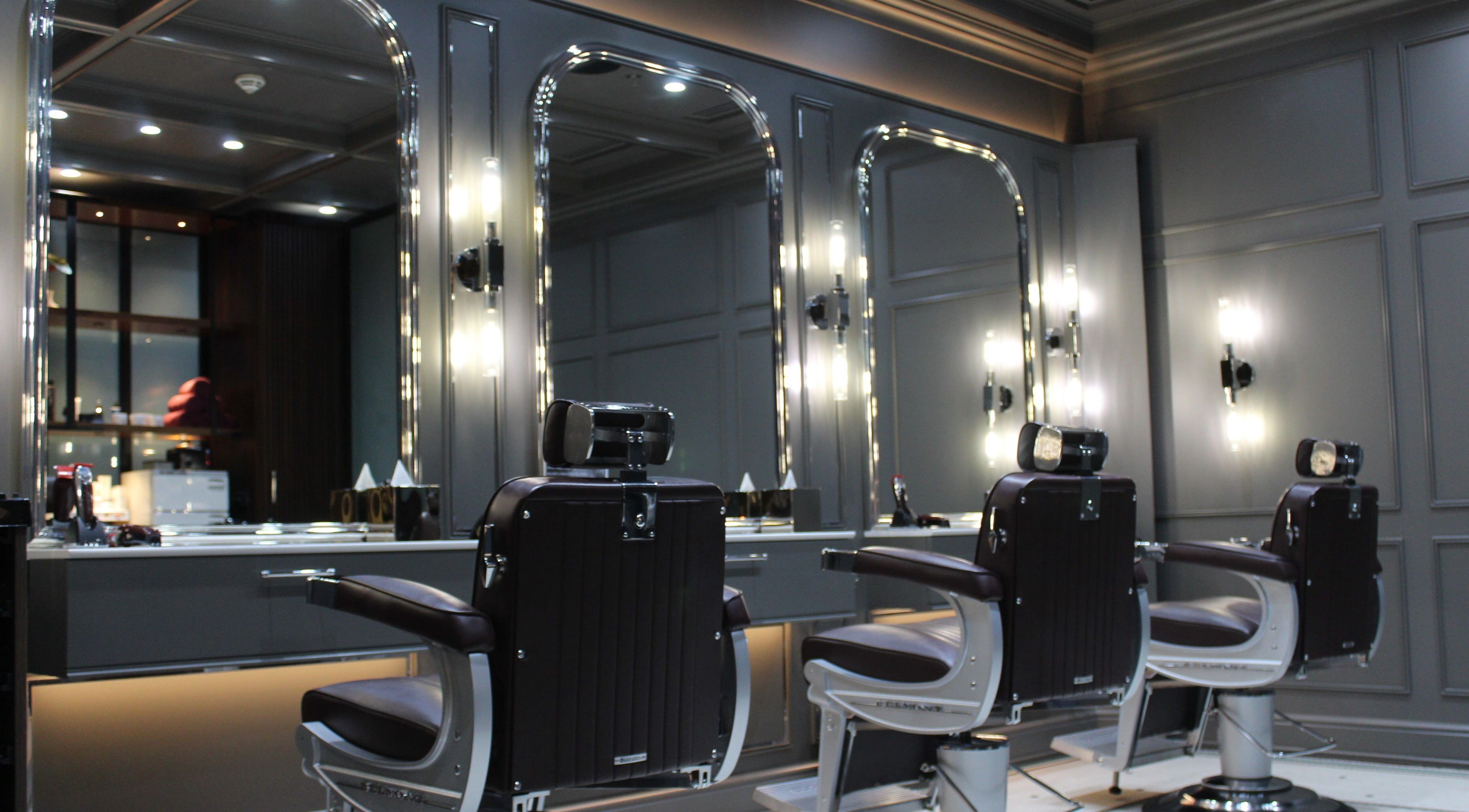 Luxurious interior of Lunatic Fringe Gentlemen's Salon in Dubai, Dubai, AE, featuring classic barber chairs.