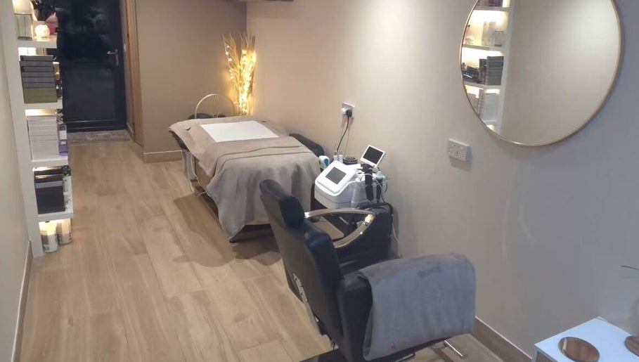 Relaxing treatment room at The Beauty Hutmcr in Dukinfield, England, GB, featuring a cozy bed and soft lighting.