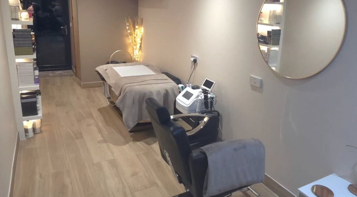 Relaxing treatment room at The Beauty Hutmcr in Dukinfield, England, GB, featuring a cozy bed and soft lighting.
