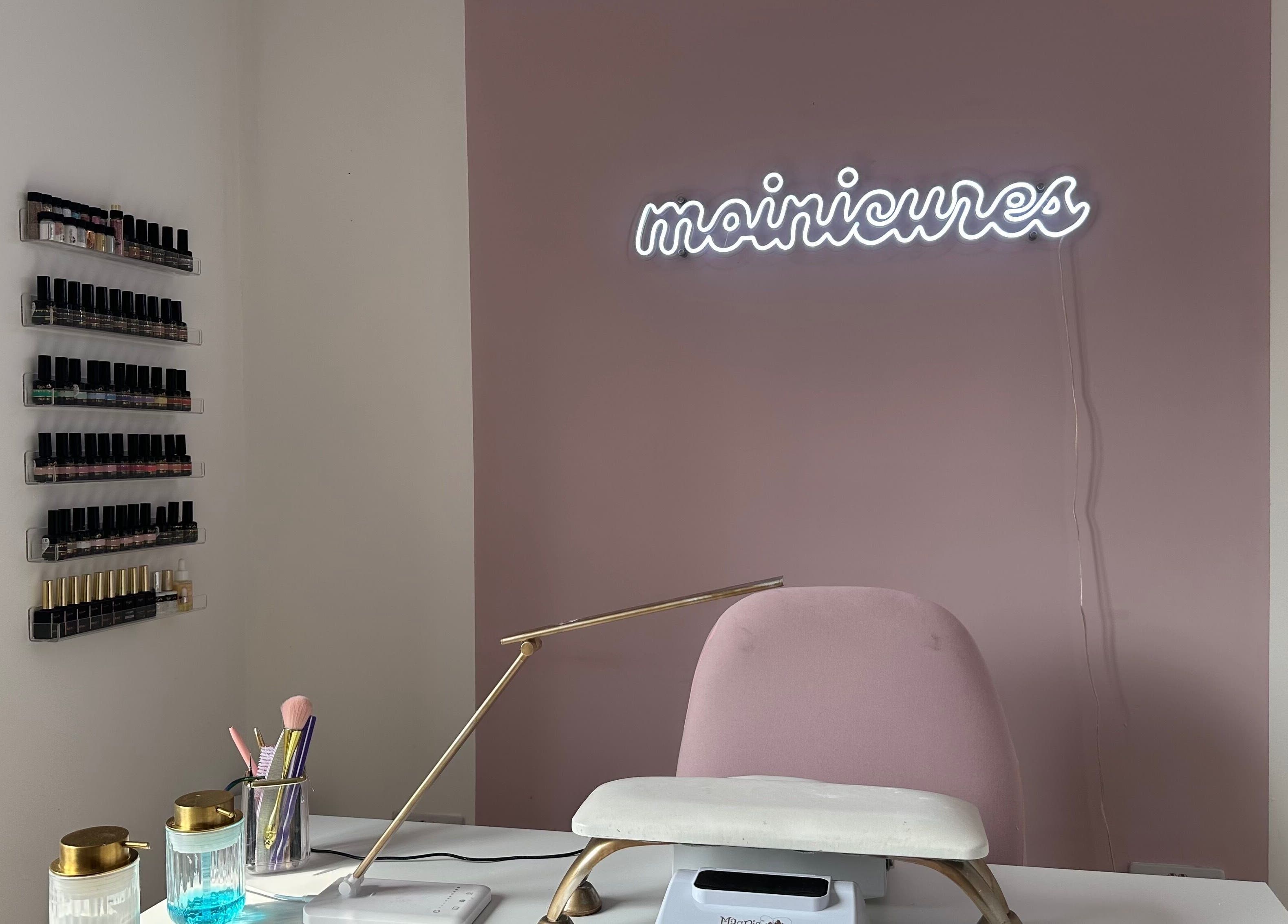 Elegant nail station at Moinicures in Barry, Wales, GB, showcasing polishes and a stylish work area.