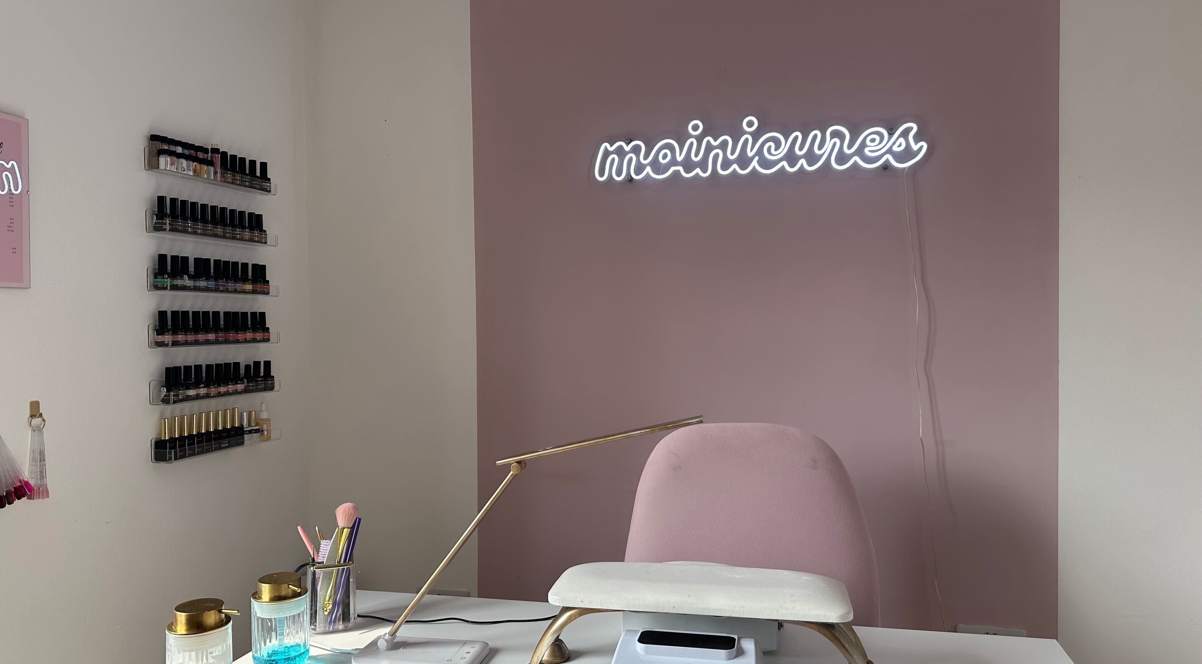 Elegant nail station at Moinicures in Barry, Wales, GB, showcasing polishes and a stylish work area.