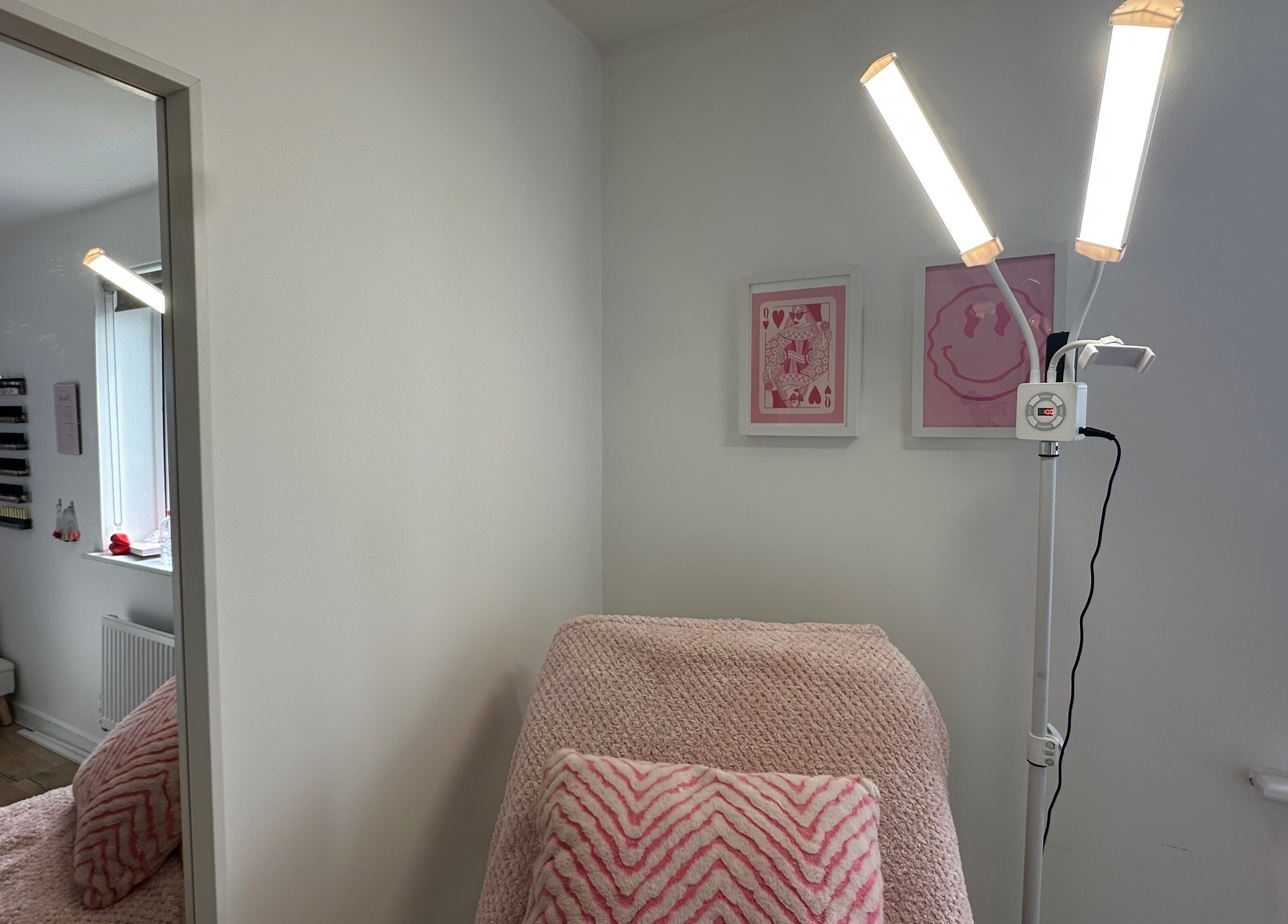 Relaxing beauty room at Moinicures in Barry, Wales, GB with soft pink decor and warm lighting.