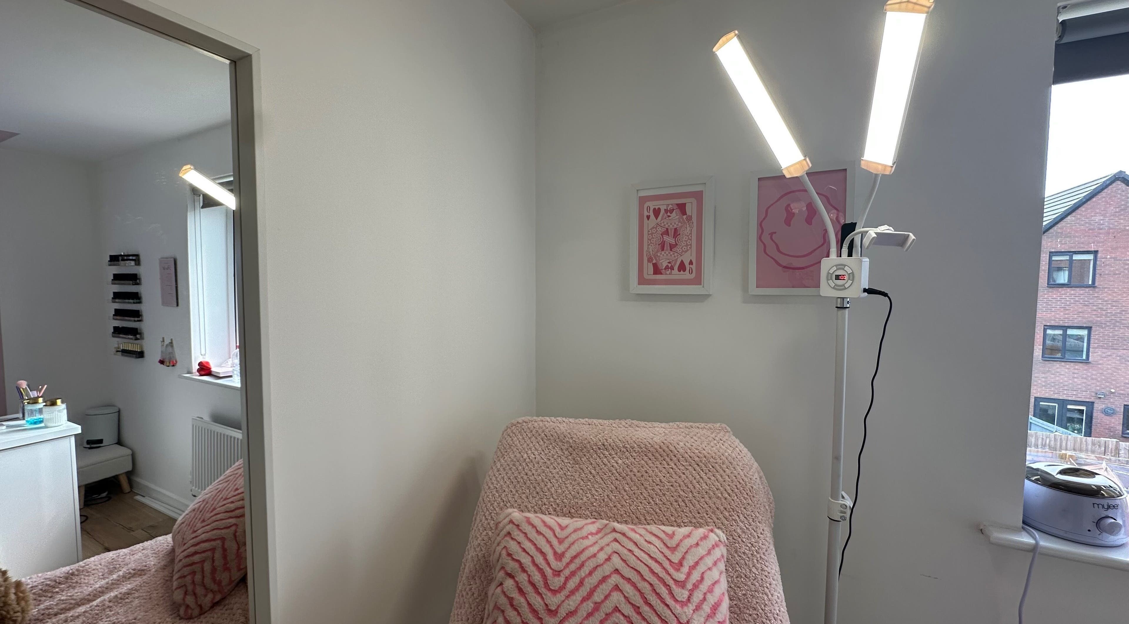 Relaxing beauty room at Moinicures in Barry, Wales, GB with soft pink decor and warm lighting.