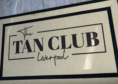 Welcome mat with 'The Tan Club Liverpool' logo at Liverpool, England, GB venue entrance.