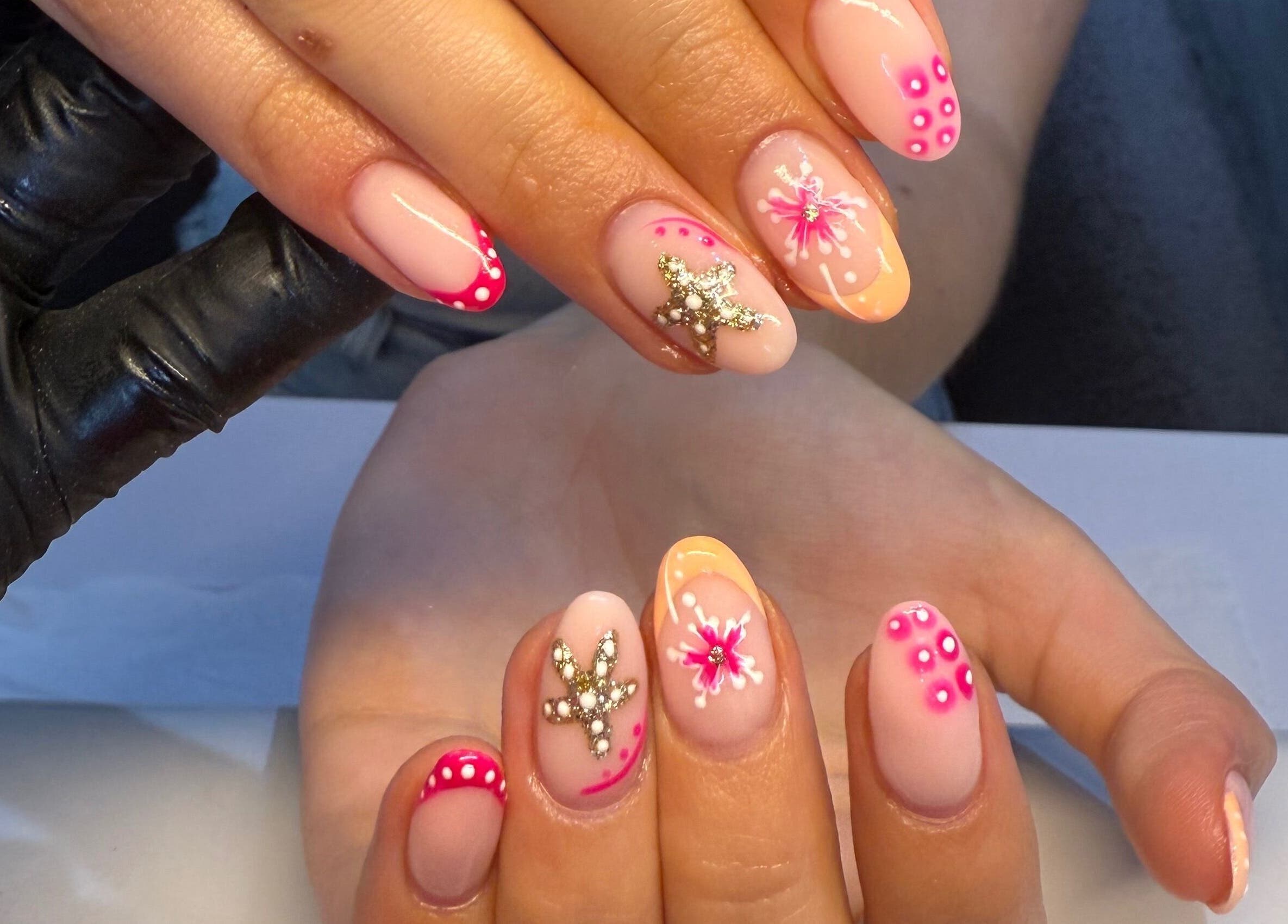 Floral glam nail art at Beauty by Soph, Wickford, England, GB, showcasing intricate jewels and pink accents.