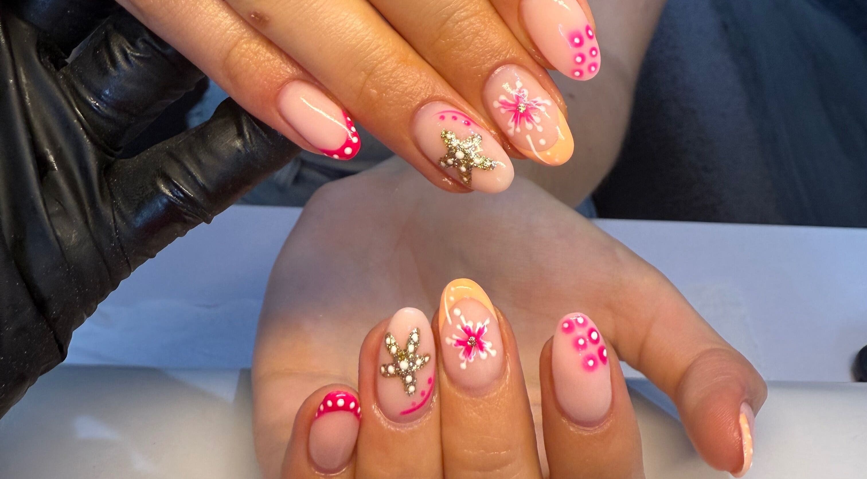 Floral glam nail art at Beauty by Soph, Wickford, England, GB, showcasing intricate jewels and pink accents.
