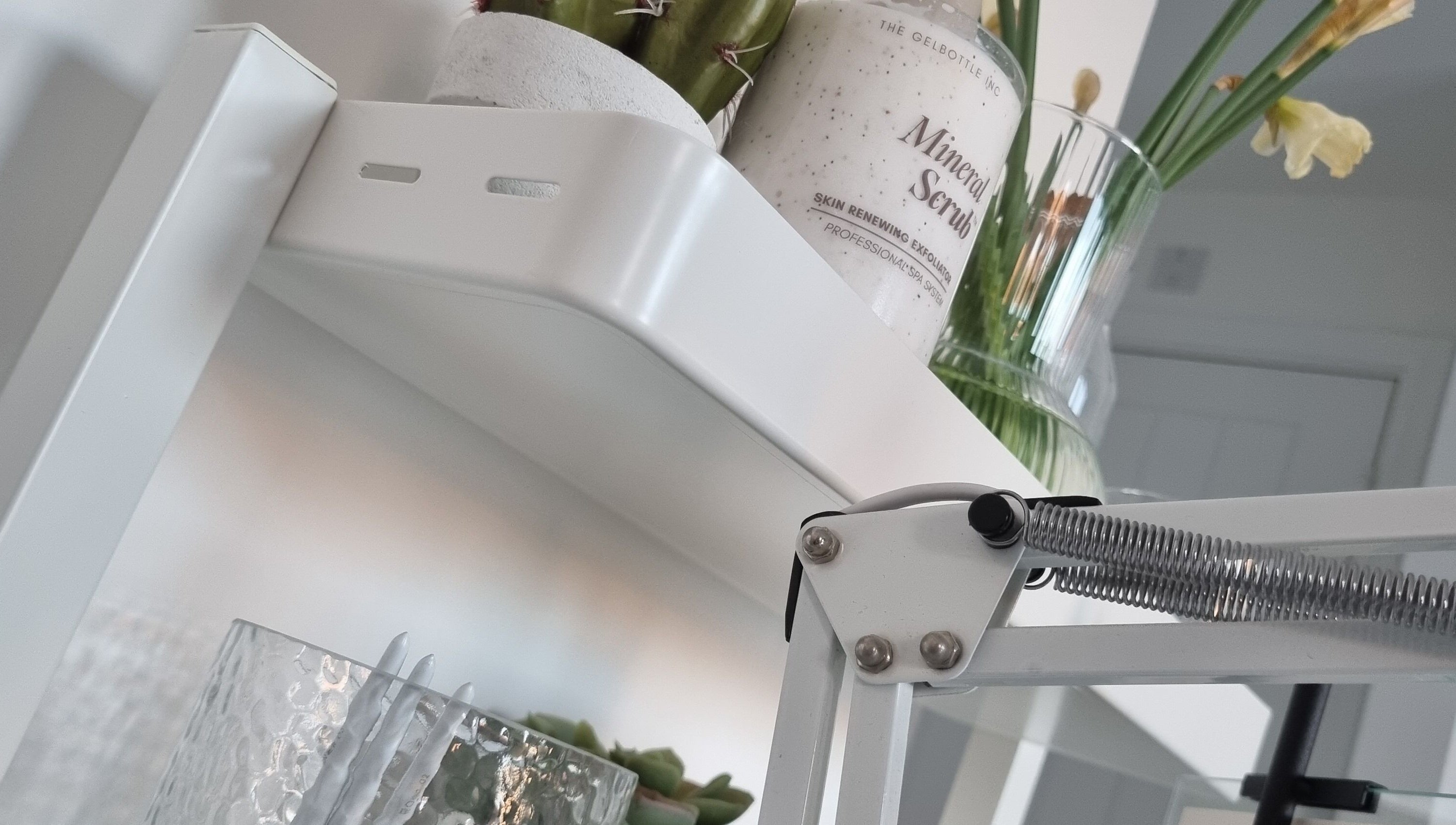 Mineral scrub on a white shelf with decor at Bare Nails, Westergate, England, GB.