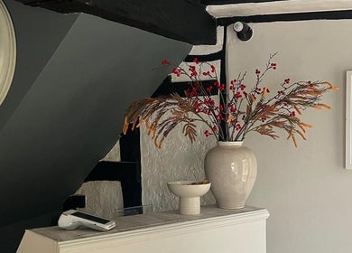 Elegant corner at F I A Nails, Beauty and Wellness, Diss, England, GB with vintage clock and vase décor.