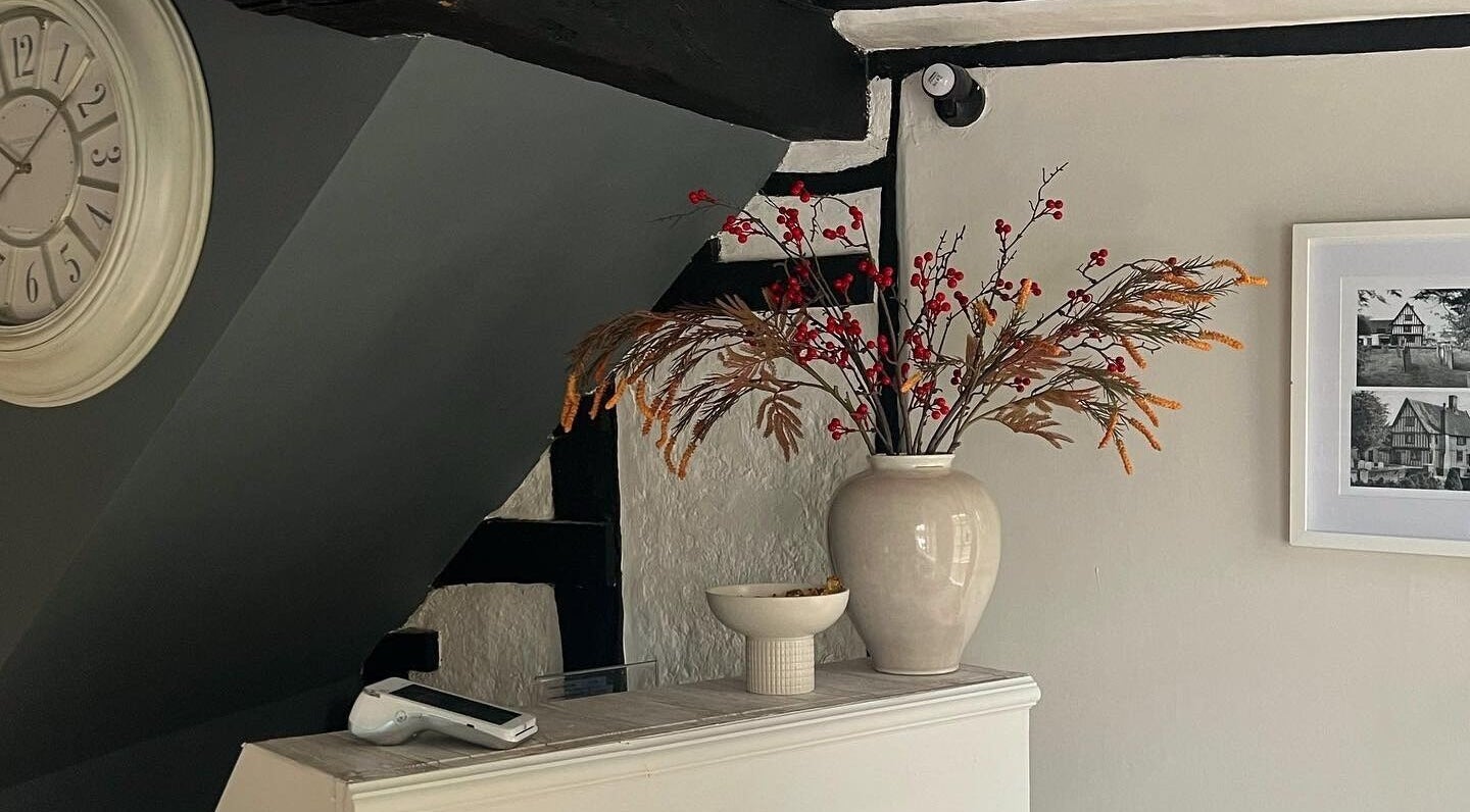 Stylish interior of F I A Nails, Beauty and Wellness in Diss, England, GB with a vase and wall clock.