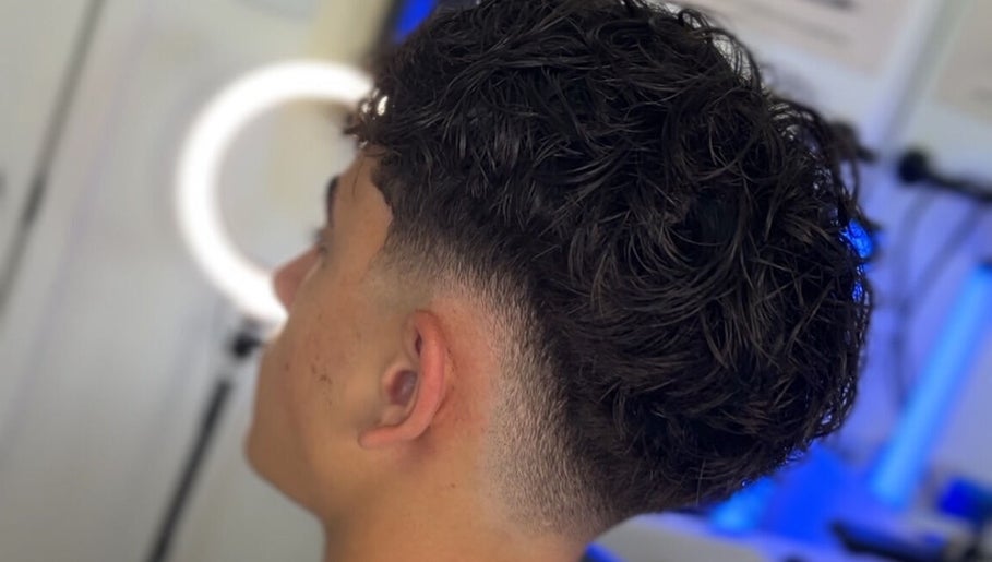Men's fresh curly haircut at Kasboi Cuts in West End, Queensland, AU highlighting a stylish fade.