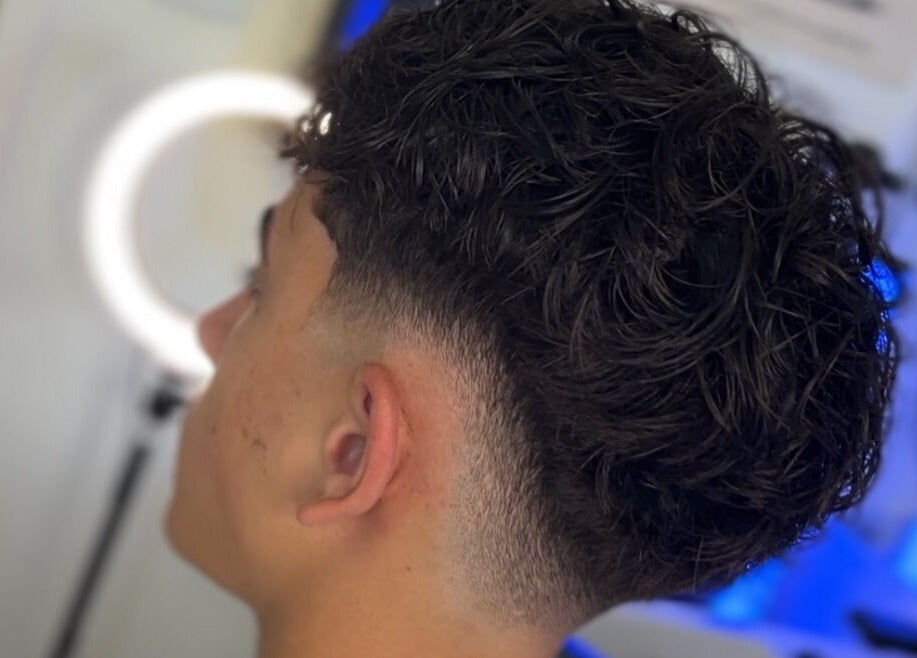 Men's fresh curly haircut at Kasboi Cuts in West End, Queensland, AU highlighting a stylish fade.