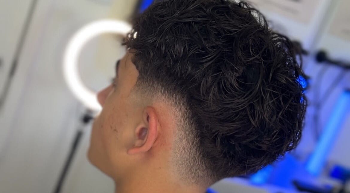 Men's fresh curly haircut at Kasboi Cuts in West End, Queensland, AU highlighting a stylish fade.