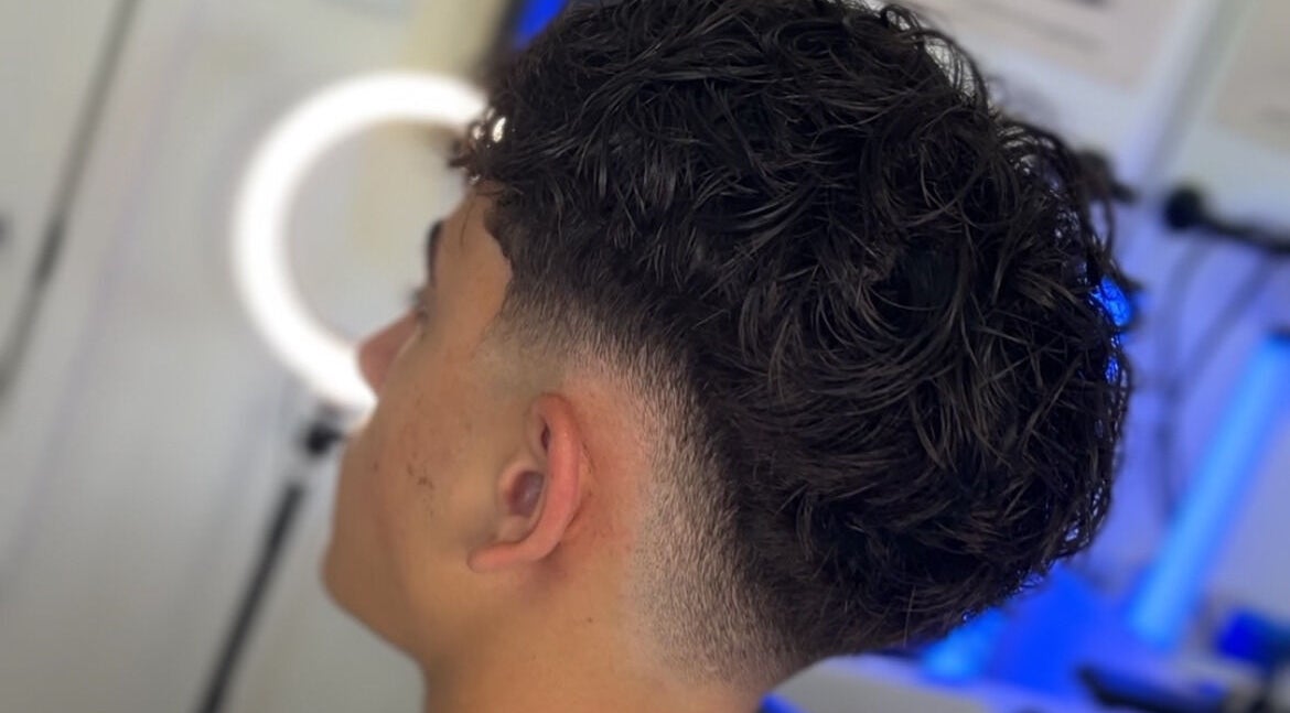 Men's fresh curly haircut at Kasboi Cuts in West End, Queensland, AU highlighting a stylish fade.