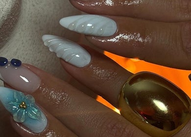 Intricate nail art at Gemi Nailz, Cleveland, Queensland, AU featuring blue and white decorations.