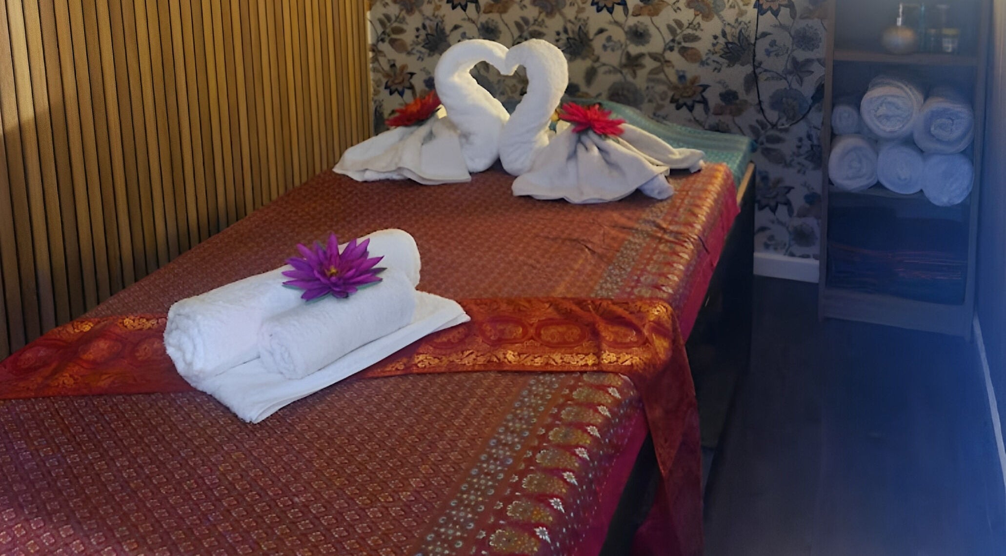 Luxurious massage room at Meesook Thai Therapy, Manchester, England, GB with elegant decor and flowers.