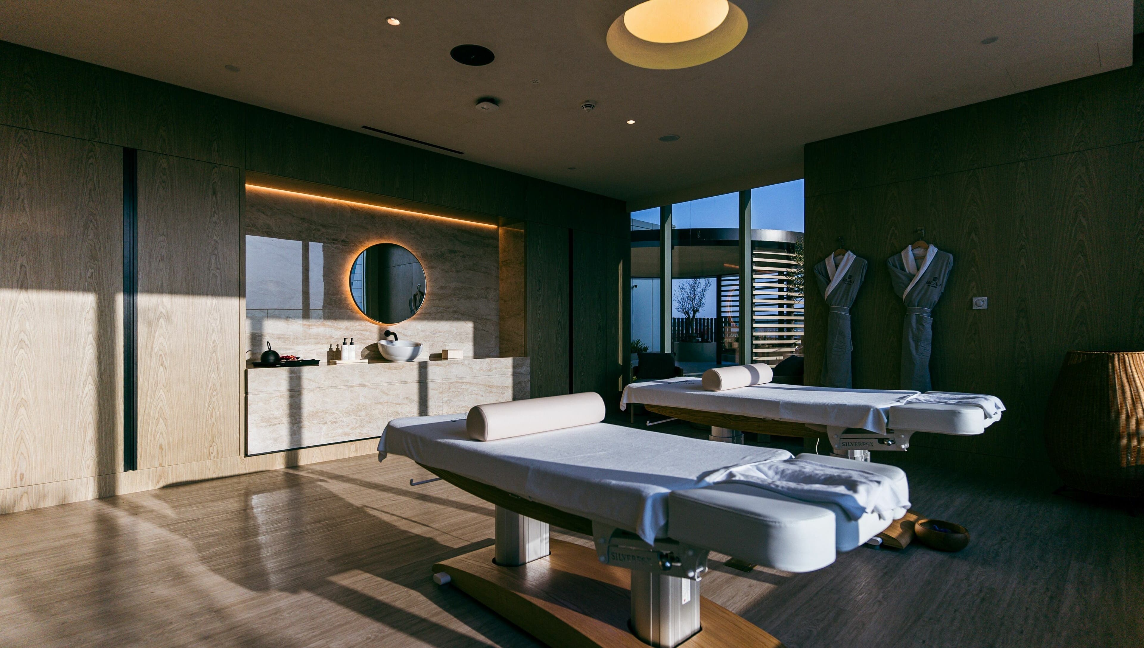 Relaxing treatment room at Blaj Spa, Dubai, AE, featuring massage tables and calming decor.