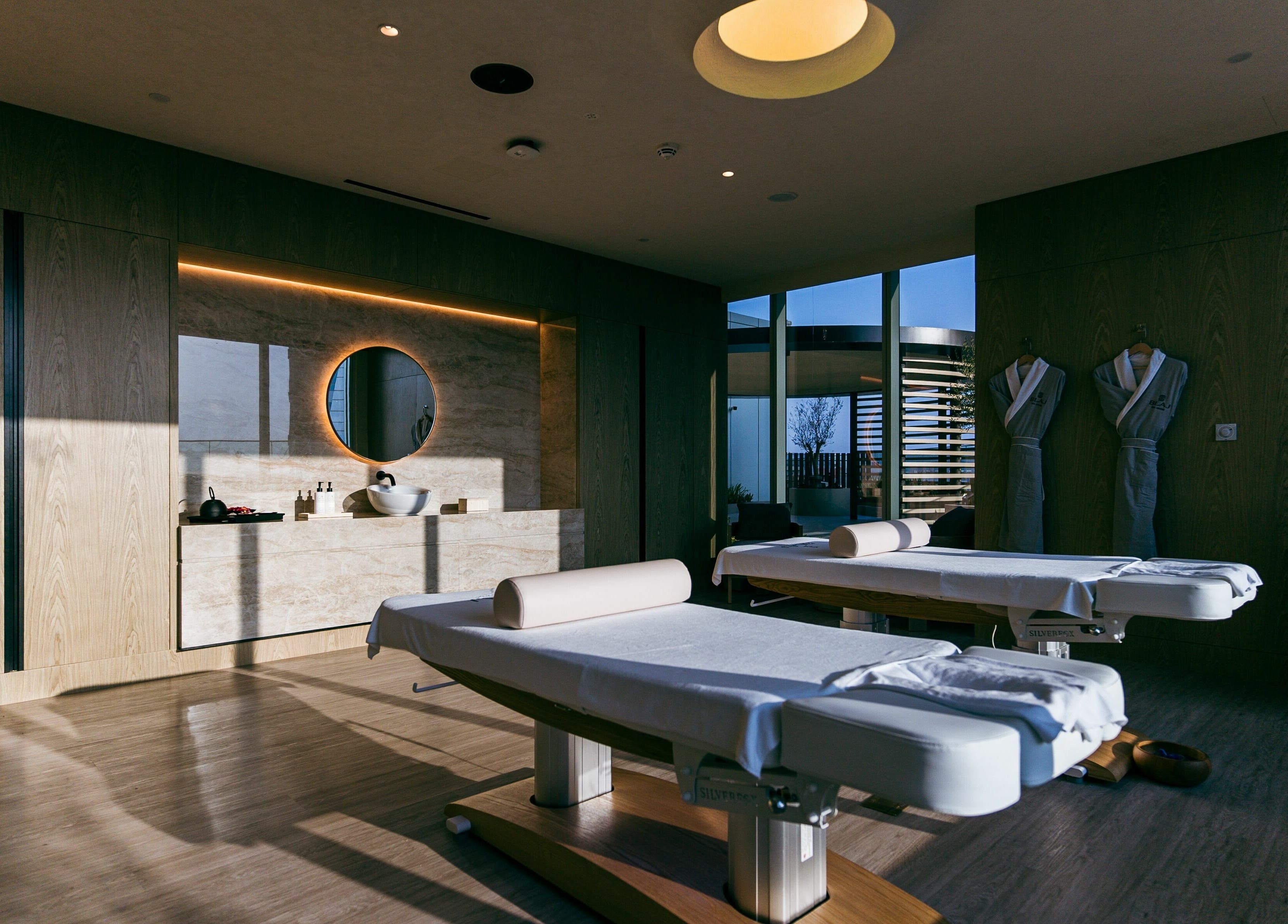 Relaxing treatment room at Blaj Spa, Dubai, AE, featuring massage tables and calming decor.