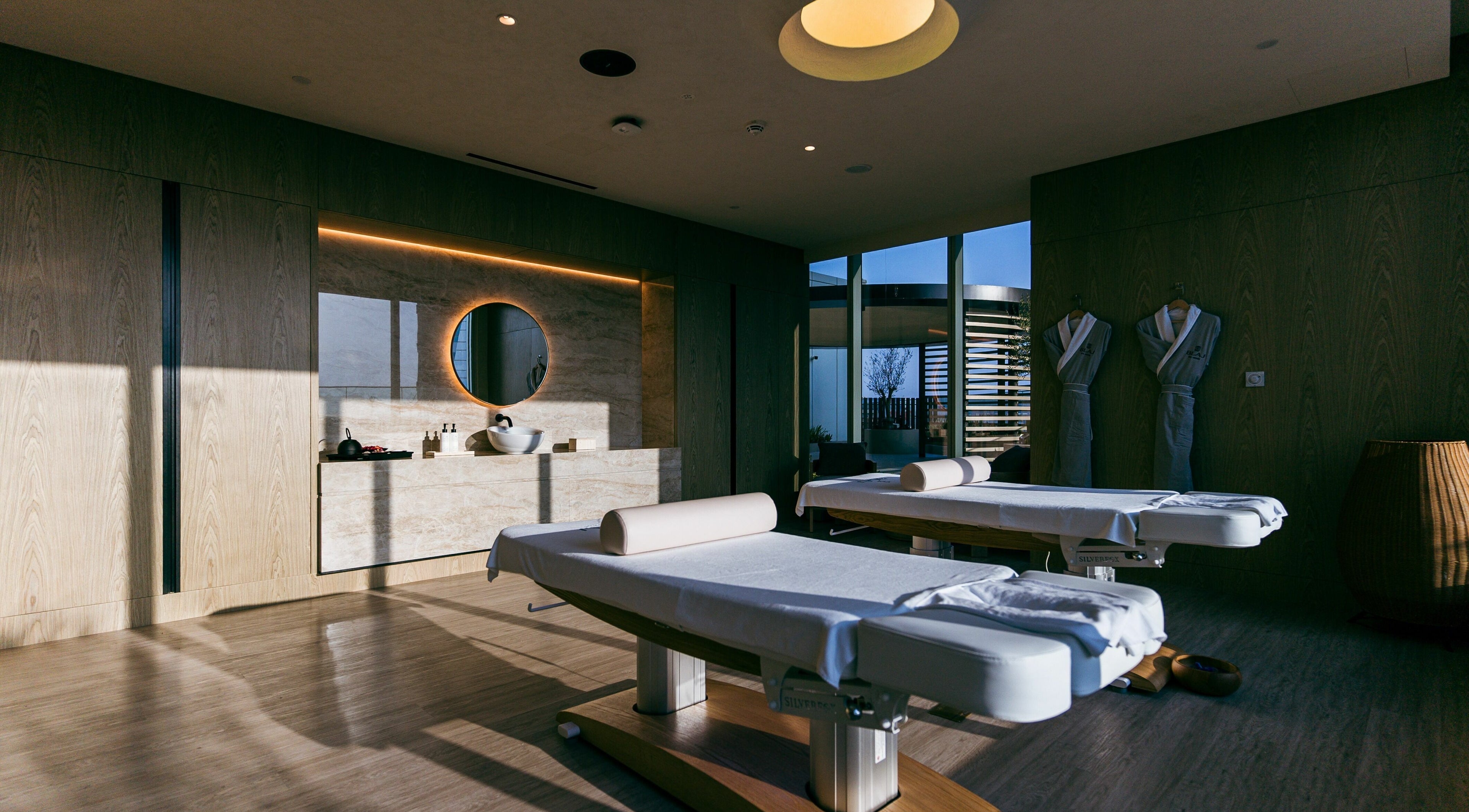 Relaxing treatment room at Blaj Spa, Dubai, AE, featuring massage tables and calming decor.
