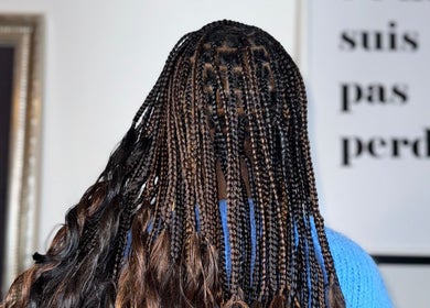 Intricate braiding style at Ennie's Braids LTD in London, England, GB. Showcasing vibrant, detailed work.