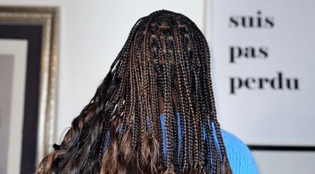 Intricate braiding style at Ennie's Braids LTD in London, England, GB. Showcasing vibrant, detailed work.