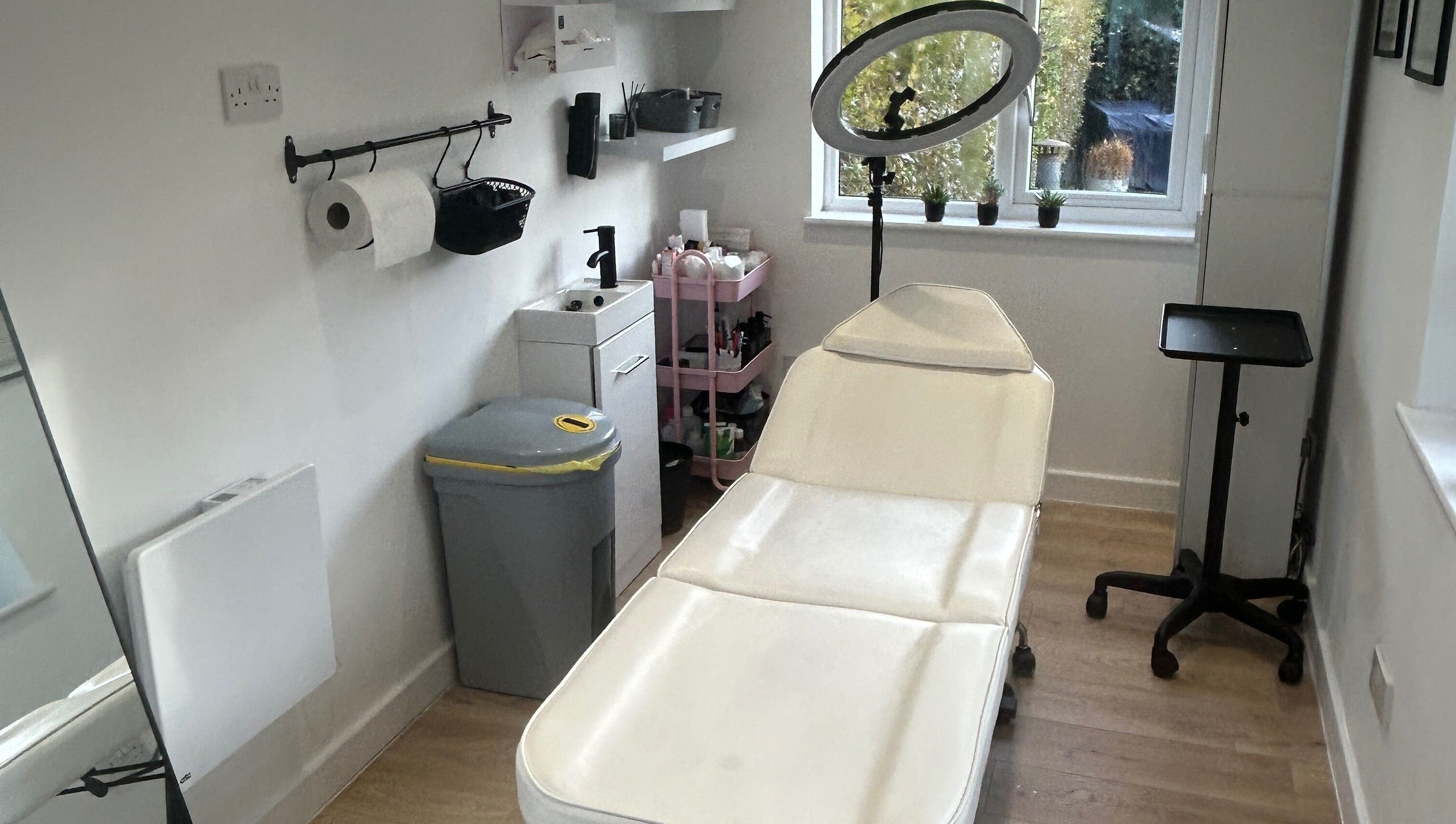 Cozy treatment room at Dayna Louise, Leeds, England, GB, featuring a modern therapy bed and natural light.