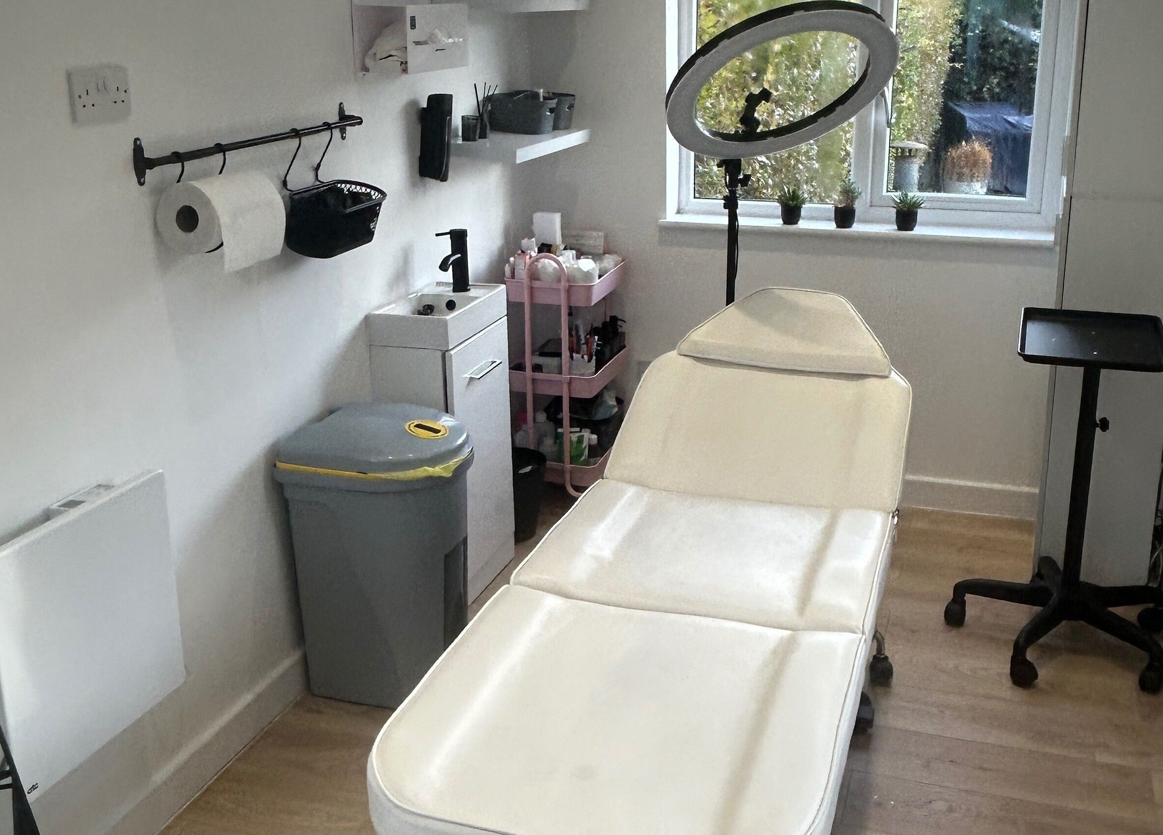 Cozy treatment room at Dayna Louise, Leeds, England, GB, featuring a modern therapy bed and natural light.